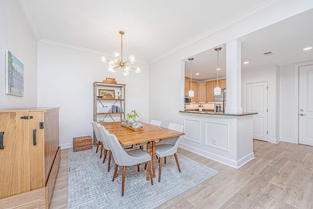 145 Pier View St Unit 214, Daniel Island, SC 29492 - dining area featuring light wood-style floors, a chandelier, ornamental molding, baseboards, and recessed lighting