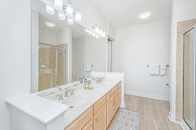 145 Pier View St Unit 214, Daniel Island, SC 29492 - bathroom featuring a stall shower, wood finished floors, double vanity, and toilet