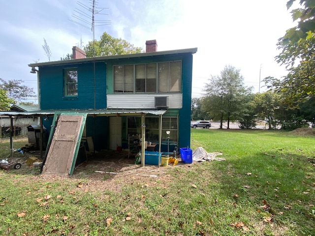 rear view of property with a yard