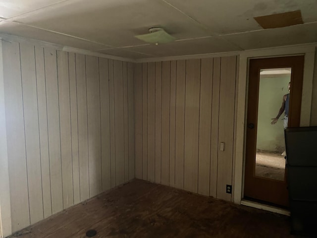 empty room featuring wood walls