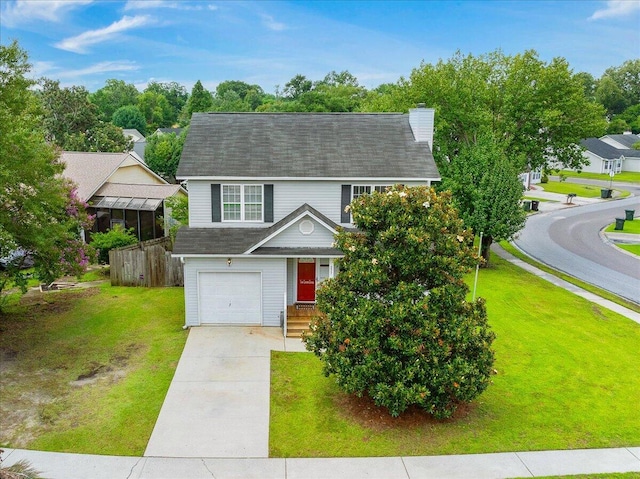 view of front of home with a front yard and a garage