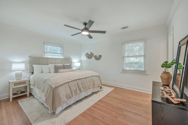 bedroom with ceiling fan, wood-type flooring, and ornamental molding