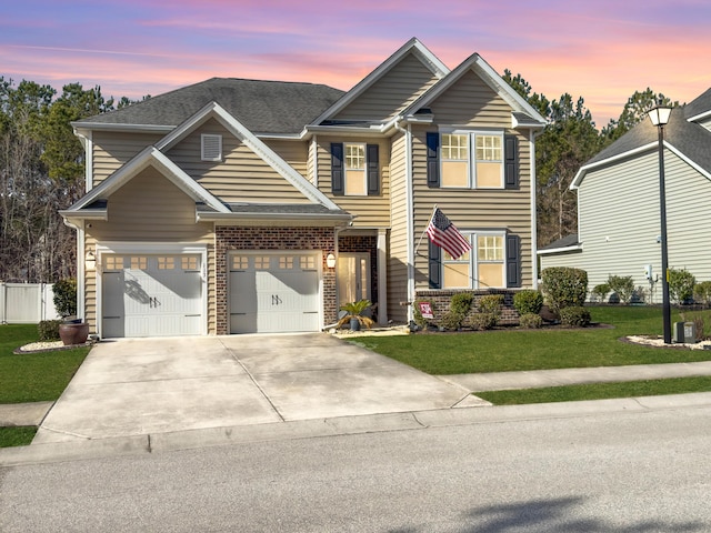 craftsman-style house featuring a yard and a garage