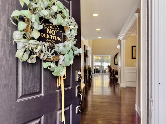 entrance foyer featuring ornamental molding and dark hardwood / wood-style floors