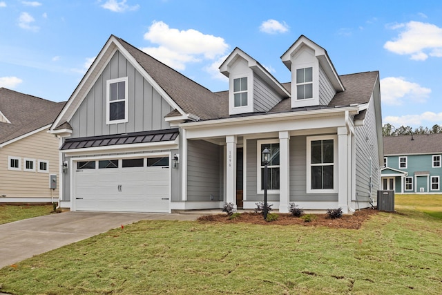 772 Opal Wing St, Moncks Corner, SC 29461 - view of front of home with concrete driveway, covered porch, a front lawn, central AC, and a garage