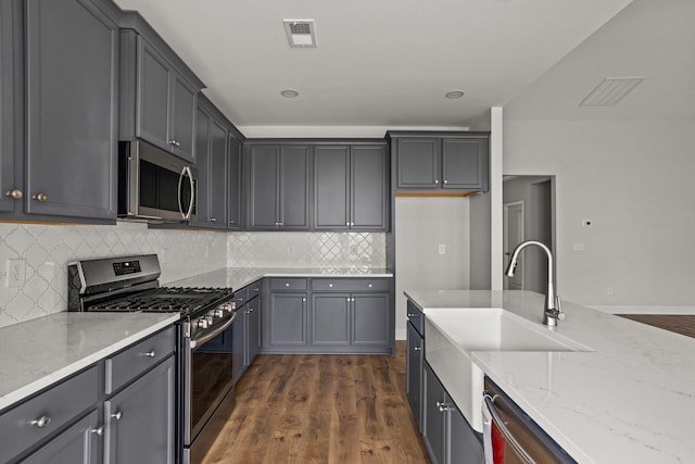 772 Opal Wing St, Moncks Corner, SC 29461 - kitchen with stainless steel appliances, light stone countertops, a sink, dark wood finished floors, and decorative backsplash