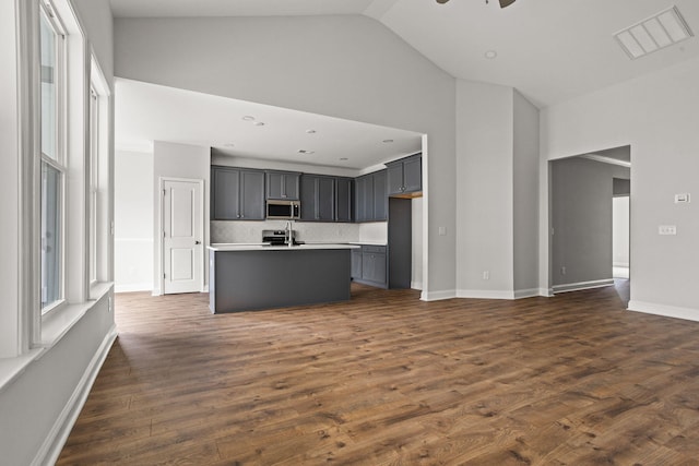 772 Opal Wing St, Moncks Corner, SC 29461 - kitchen with appliances with stainless steel finishes, high vaulted ceiling, a kitchen island with sink, backsplash, and light countertops