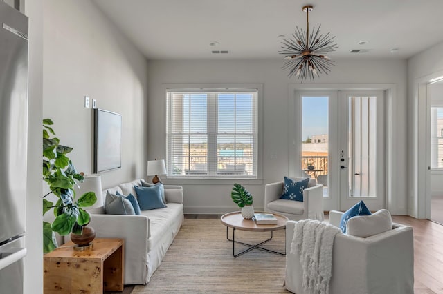 living room featuring french doors and light wood-type flooring