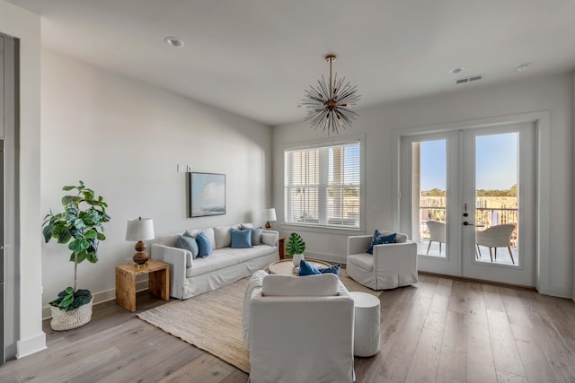 living room with light hardwood / wood-style floors and french doors