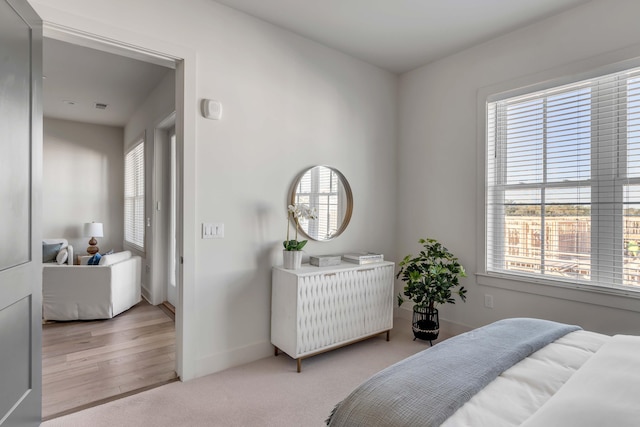 carpeted bedroom featuring multiple windows