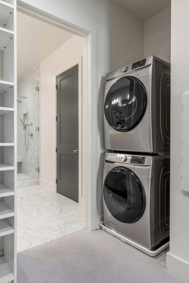 laundry area featuring stacked washer / drying machine and light colored carpet