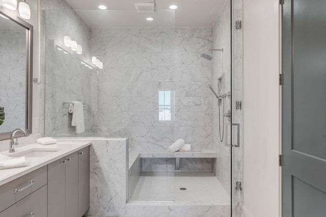 bathroom featuring vanity and a shower with shower door