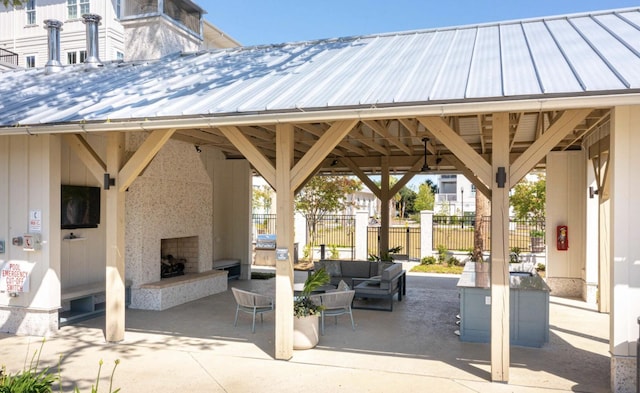 view of patio with an outdoor living space with a fireplace