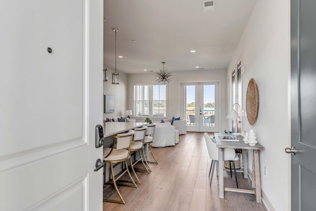 interior space with wood-type flooring and french doors