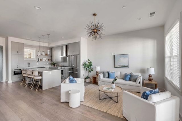 living room featuring plenty of natural light and light hardwood / wood-style flooring