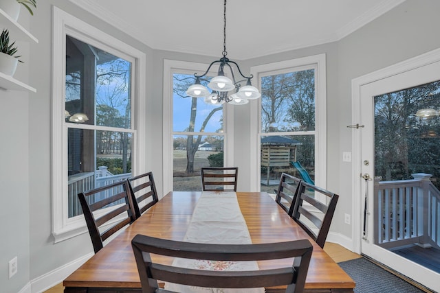 dining room with ornamental molding, a healthy amount of sunlight, and wood-type flooring