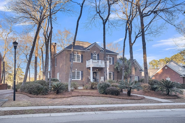 colonial inspired home featuring a balcony