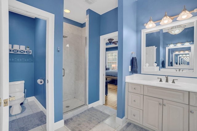 bathroom featuring ceiling fan, tile patterned floors, a shower with door, and toilet