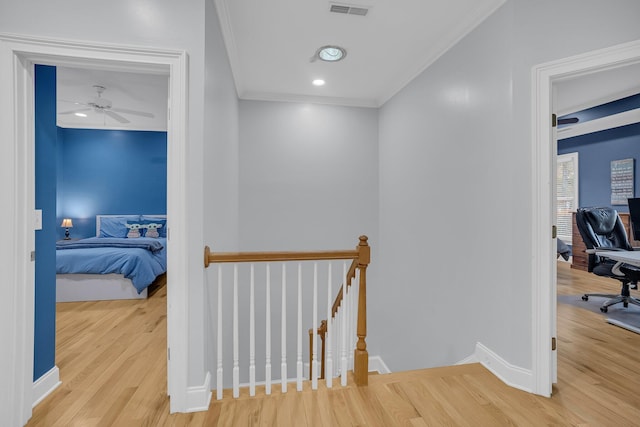 hall with crown molding and wood-type flooring