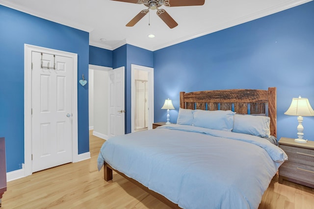 bedroom with ceiling fan, ornamental molding, and light hardwood / wood-style floors