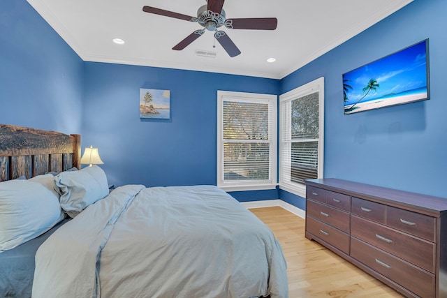 bedroom featuring ceiling fan, ornamental molding, and light wood-type flooring