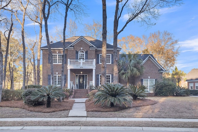 colonial inspired home featuring a balcony