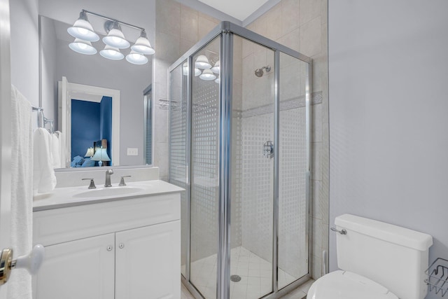 bathroom with vanity, toilet, and an enclosed shower