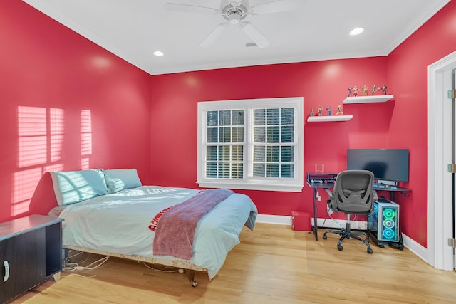 bedroom with hardwood / wood-style flooring, crown molding, and ceiling fan