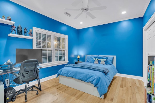 bedroom featuring wood-type flooring, ornamental molding, and ceiling fan