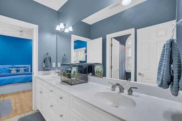 bathroom featuring hardwood / wood-style flooring, ceiling fan, and vanity