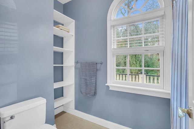 bathroom featuring tile patterned flooring and toilet