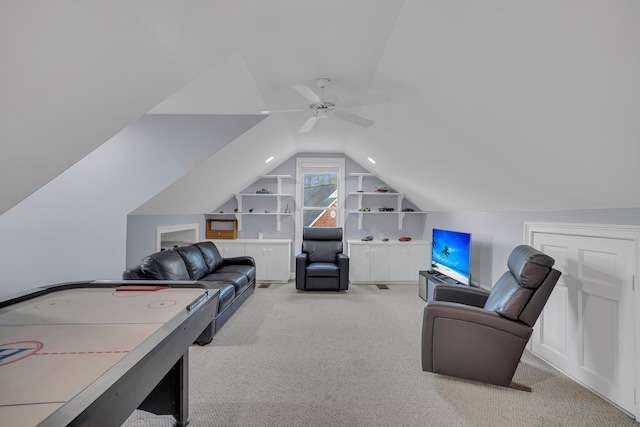 playroom featuring built in shelves, light colored carpet, and vaulted ceiling