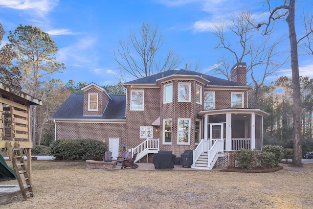 view of front facade with a front lawn and a sunroom