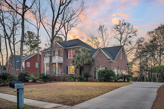 view of front of property with a garage and a yard