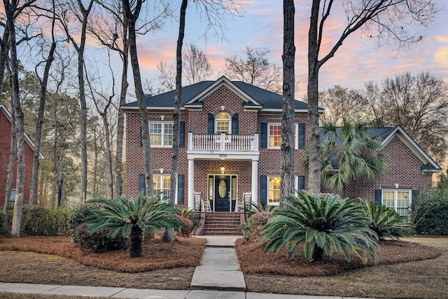 colonial-style house with a balcony