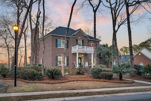 colonial-style house featuring a balcony