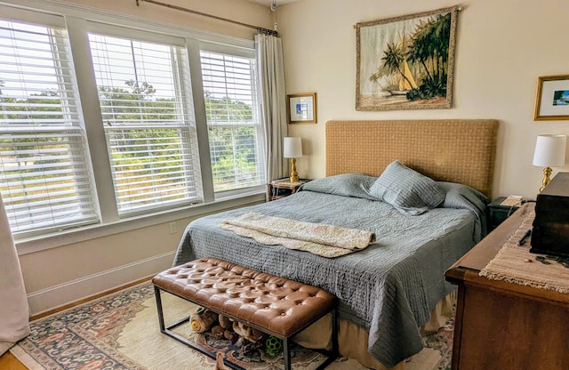 bedroom featuring baseboards and wood finished floors