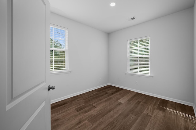 unfurnished room featuring dark wood-type flooring