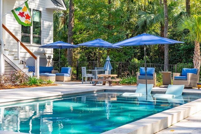 view of swimming pool featuring an outdoor living space and a patio area