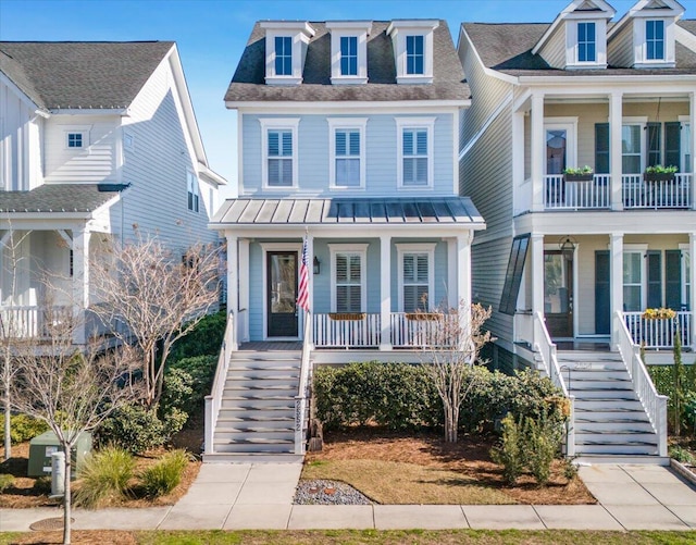 raised beach house with a standing seam roof, stairway, and covered porch