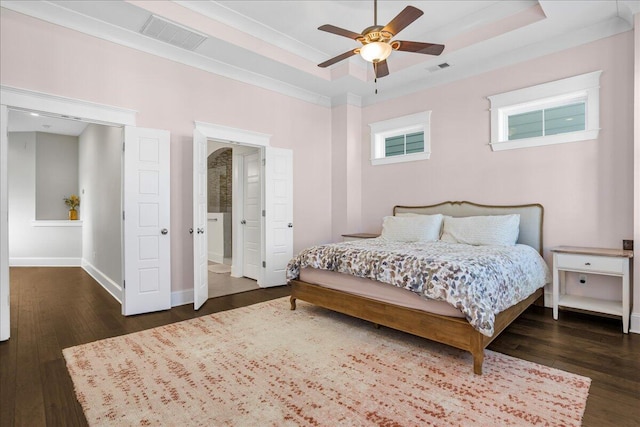 bedroom with visible vents, a raised ceiling, and wood-type flooring