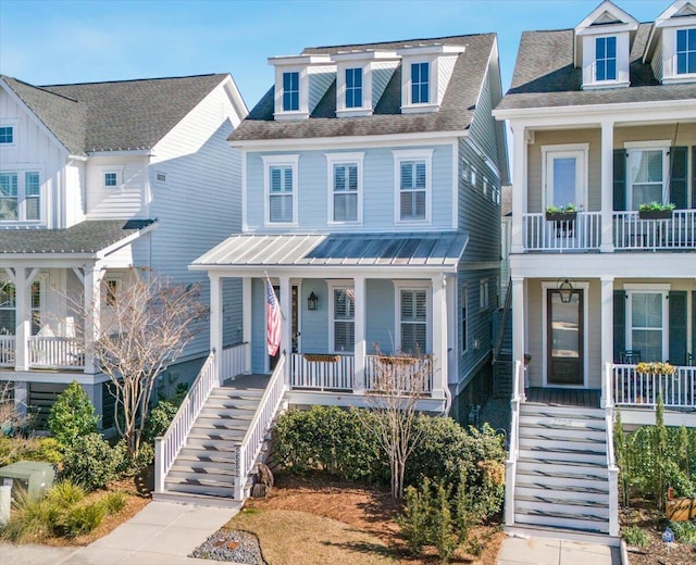 coastal inspired home with stairway and a porch