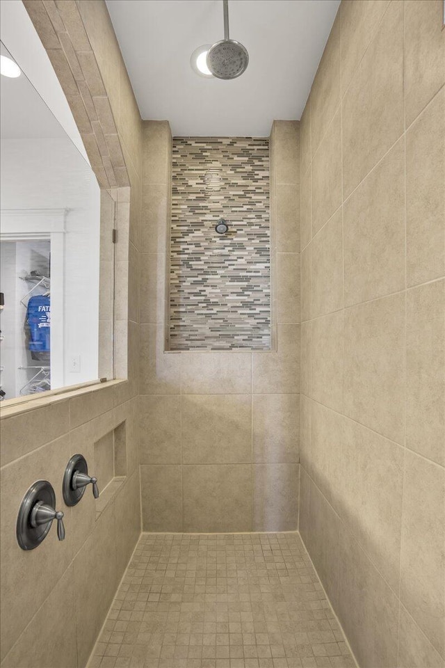 bathroom with a tile shower