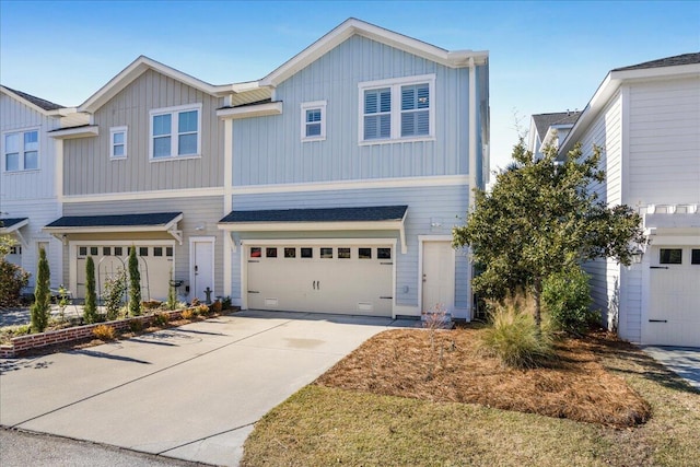 view of front of home with board and batten siding, concrete driveway, and a garage