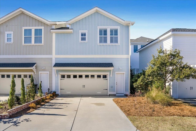 view of front of home featuring a garage, board and batten siding, driveway, and a shingled roof