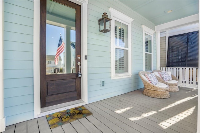 view of exterior entry with covered porch