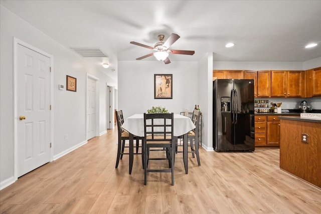 dining room with ceiling fan and light wood-type flooring