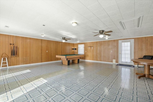 recreation room with billiards, ceiling fan, and wood walls