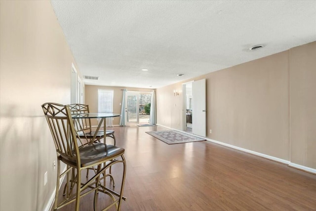 interior space featuring hardwood / wood-style floors and a textured ceiling