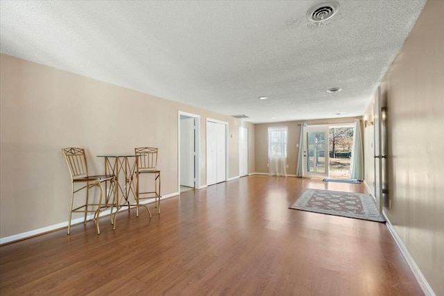 interior space with hardwood / wood-style floors and a textured ceiling